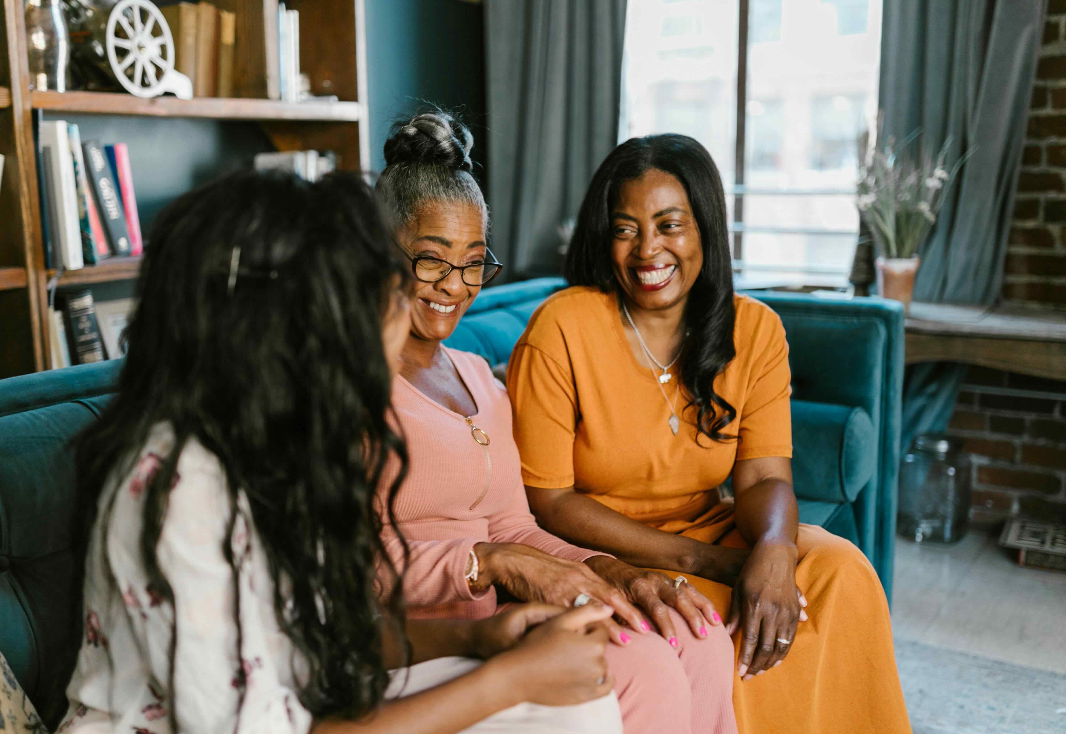 Woman using a laptop while sitting on the couch.
