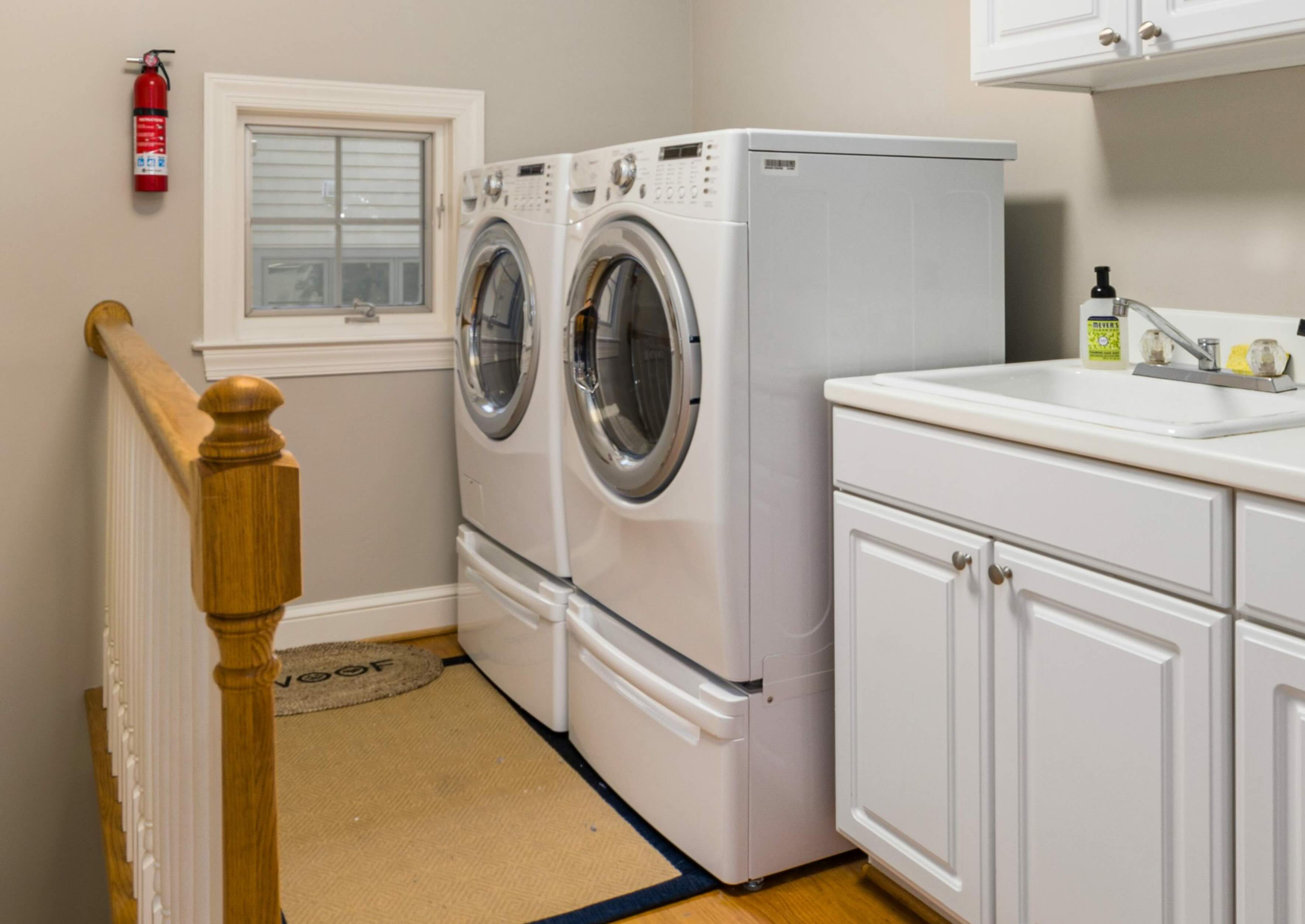 Woman using a laptop while sitting on the couch.